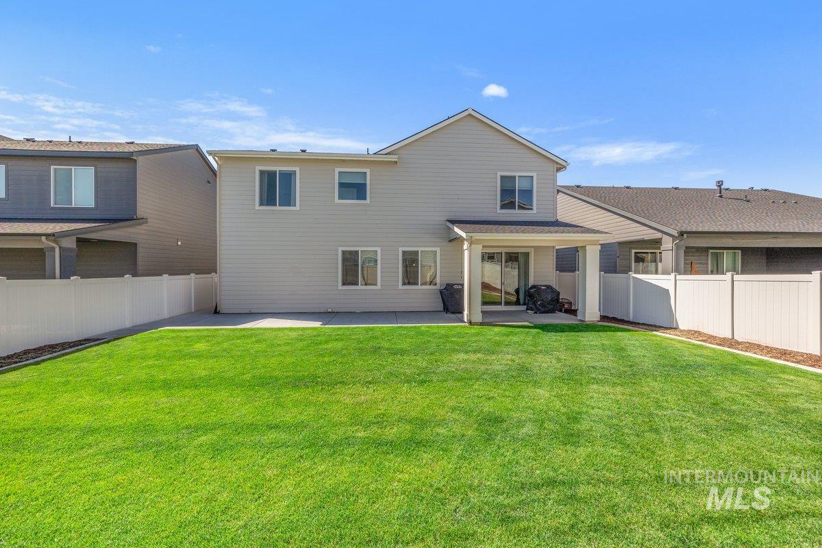 1380 West Chilitna Street Meridian, ID 83642 - Photo 42 of 50 Spacious backyard with a large grass lawn, surrounded by white fencing