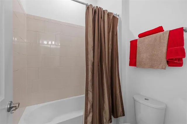a bathroom with a shower curtain and a sink