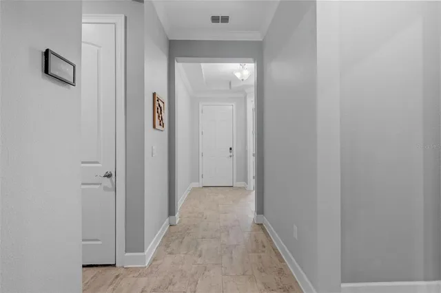 a view of a hallway with wooden floor and a hallway