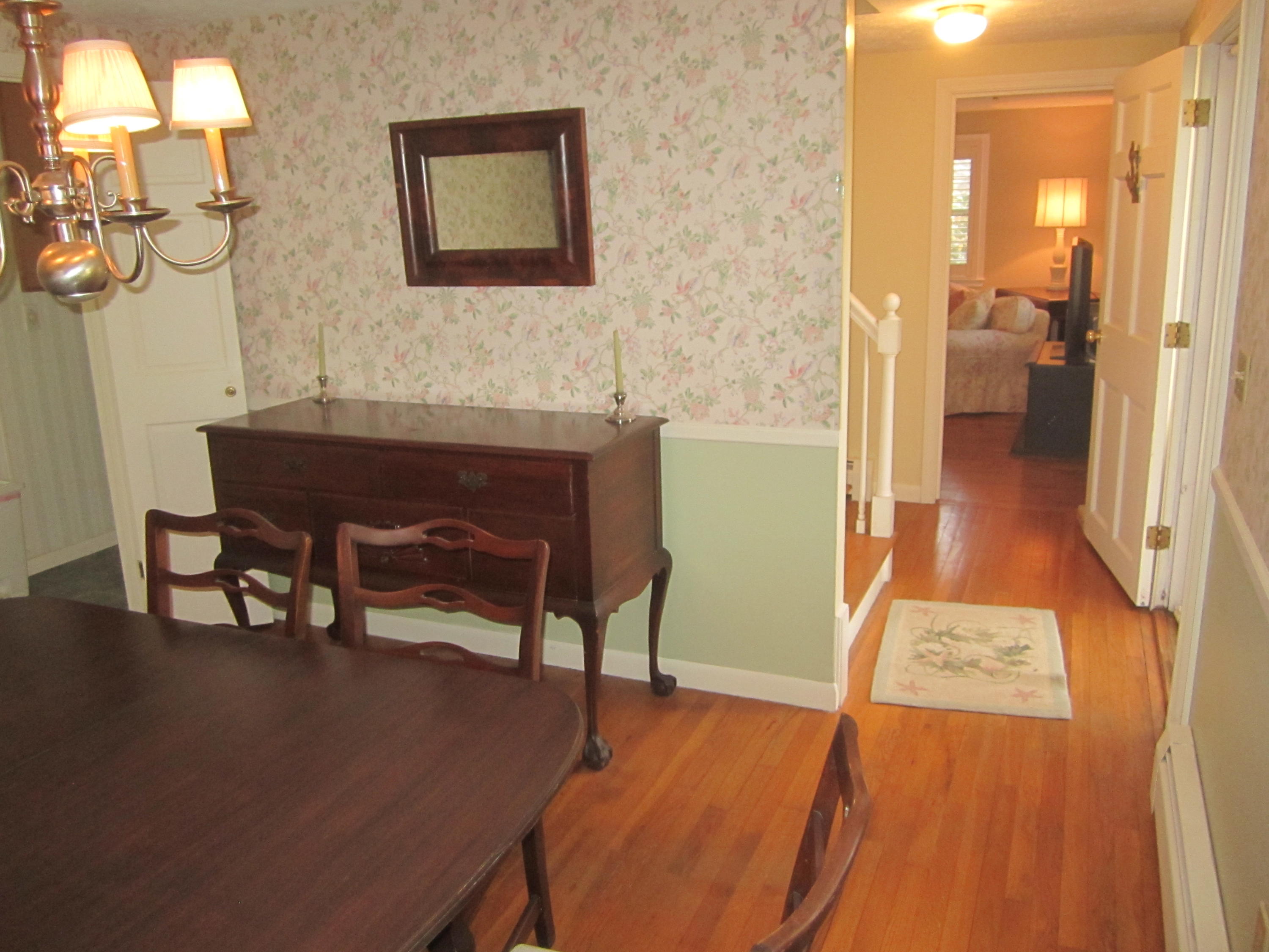 380 Jones Road Marstons Mills, MA 02648 - Photo 11 of 33 a living room with a table chairs and a wooden floor