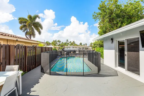 a view of house with swimming pool and sitting area