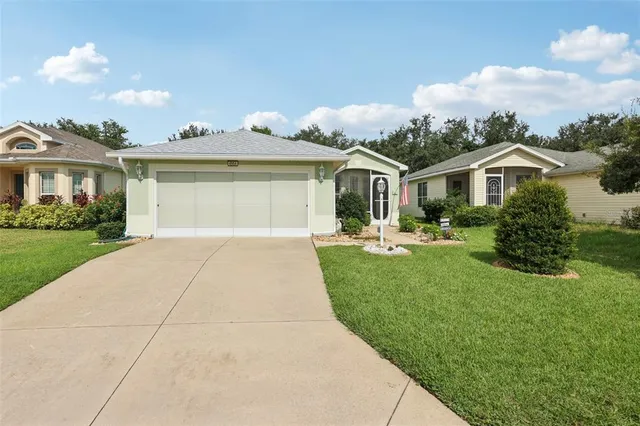a front view of a house with a garden and plants