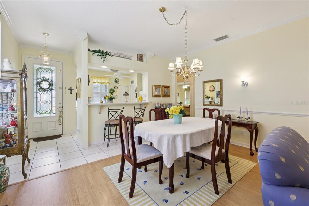 4954 Rainbow Trout Road Tavares, FL 32778 - Photo 13 of 37 a view of a dining room with furniture and wooden floor
