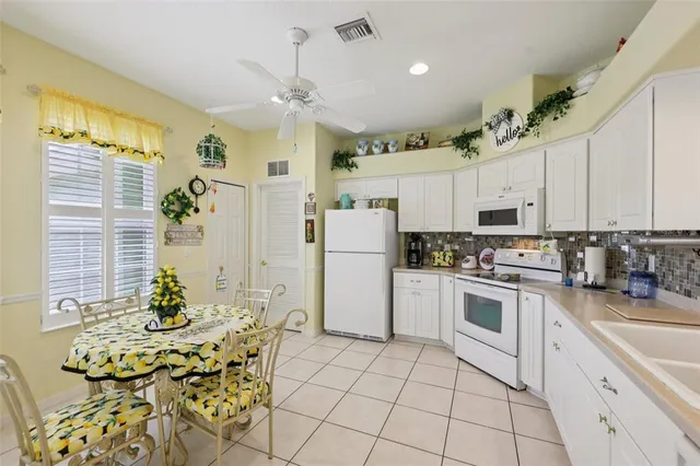 a kitchen with a white center island and appliances