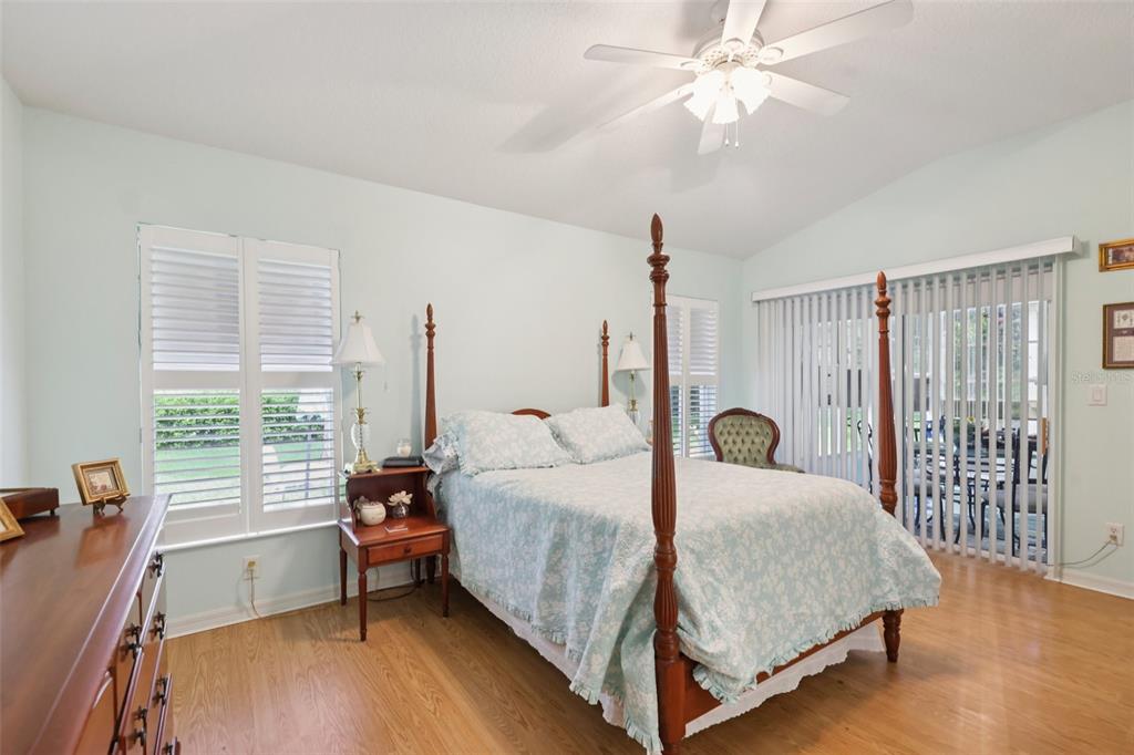 4954 Rainbow Trout Road Tavares, FL 32778 - Photo 21 of 37 a bed room with a bed and a chandelier