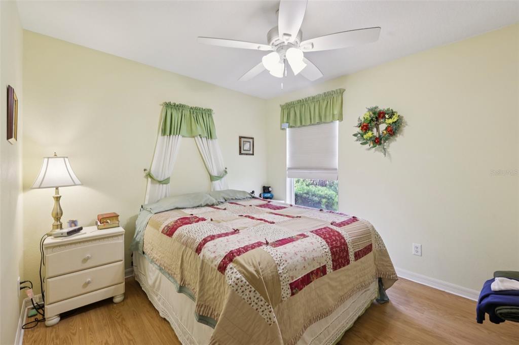 4954 Rainbow Trout Road Tavares, FL 32778 - Photo 28 of 37 a bedroom with a bed and a chandelier