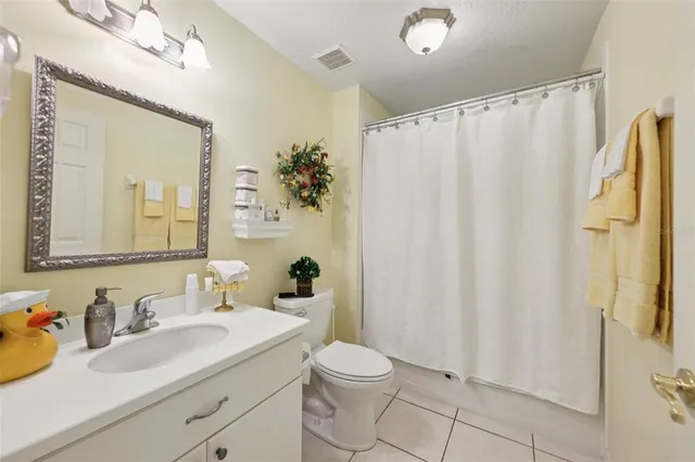 a bathroom with a sink vanity mirror and toilet