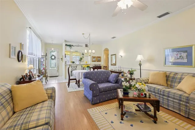 a living room with furniture and a chandelier