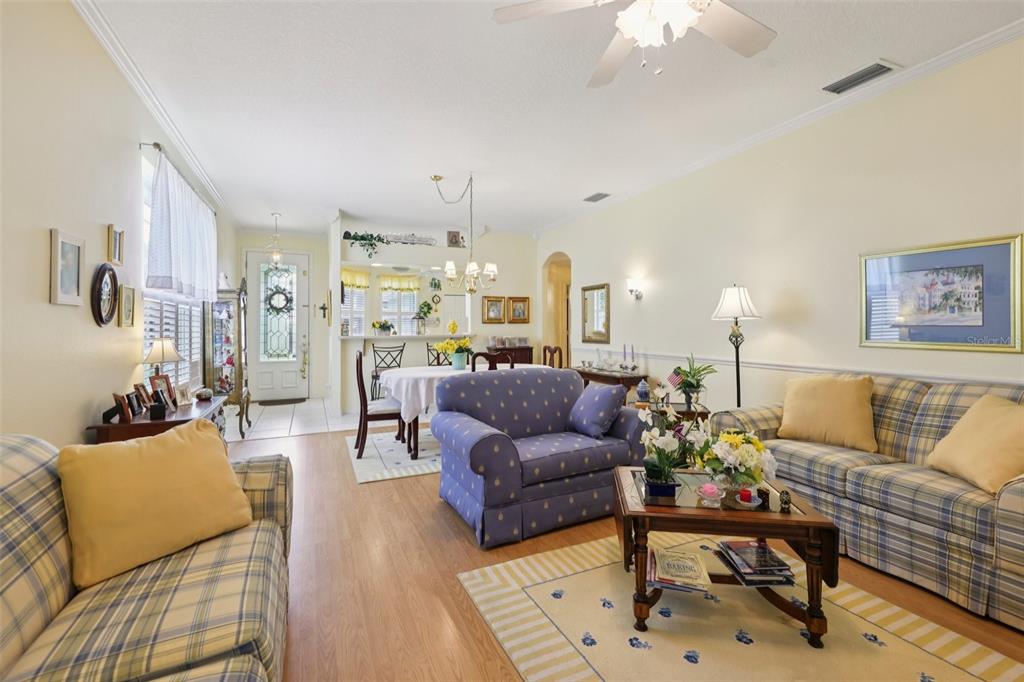 4954 Rainbow Trout Road Tavares, FL 32778 - Photo 9 of 37 a living room with furniture and a chandelier