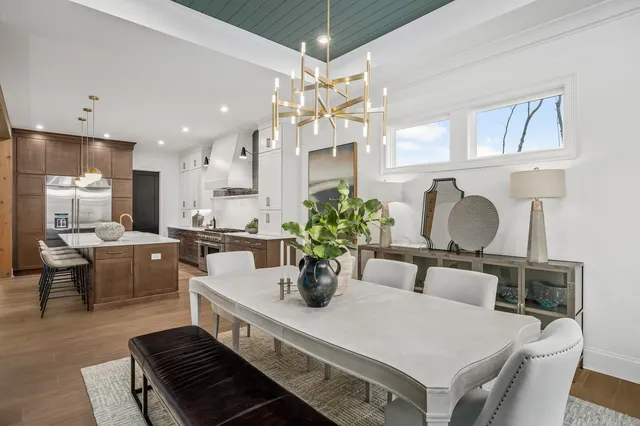 a view of a kitchen with white cabinets and refrigerator