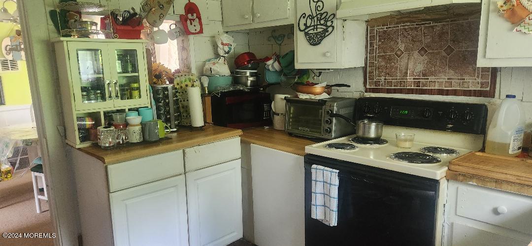 902 Adelphia Road Freehold, NJ 07728 - Photo 7 of 14 a kitchen with a sink stove and cabinets