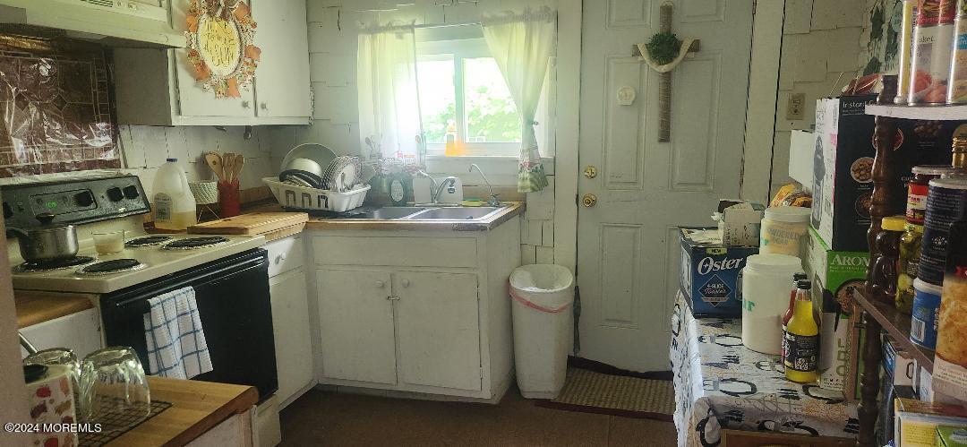 902 Adelphia Road Freehold, NJ 07728 - Photo 9 of 14 a kitchen with a sink a stove and cabinets