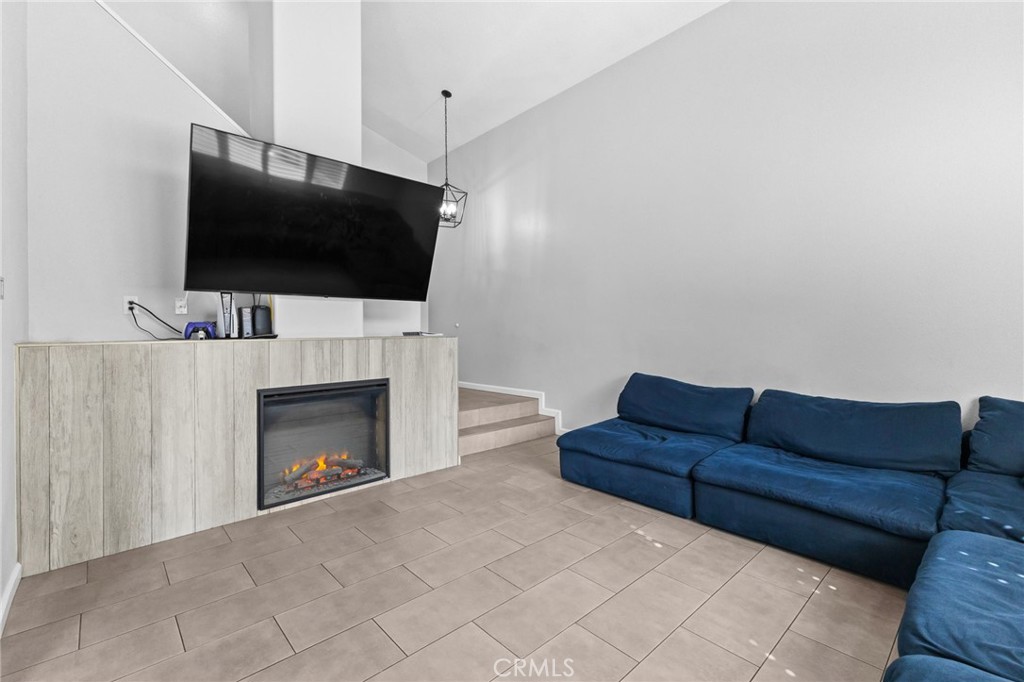 823 Pathfinder Way Corona, CA 92878 - Photo 11 of 59 a living room with furniture a flat screen tv and a fireplace