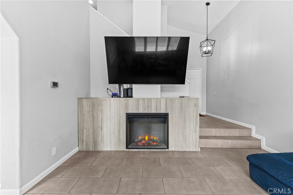 823 Pathfinder Way Corona, CA 92878 - Photo 13 of 59 a living room with furniture a fireplace and a flat screen tv