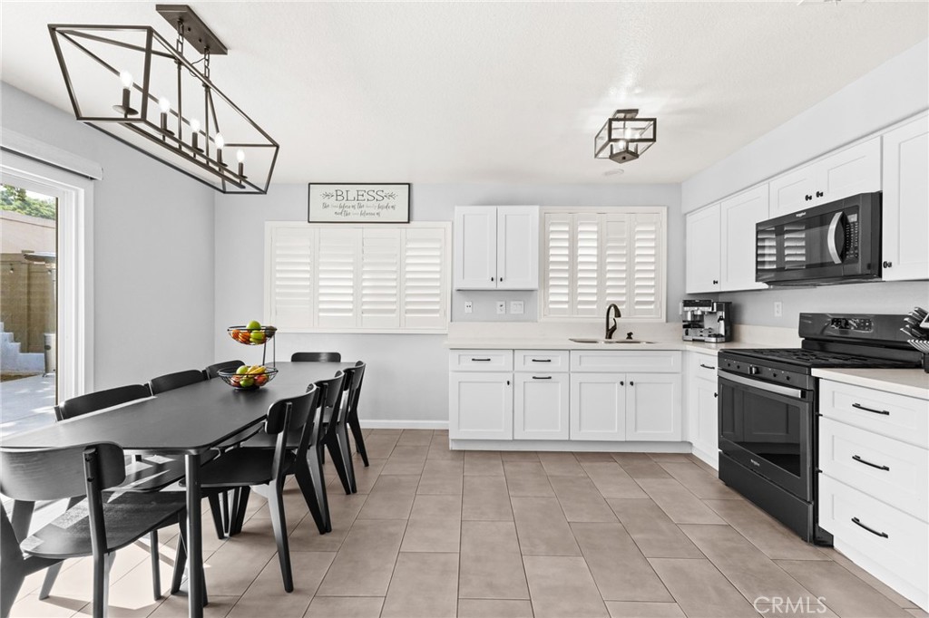 823 Pathfinder Way Corona, CA 92878 - Photo 16 of 59 a kitchen with granite countertop a sink and appliances
