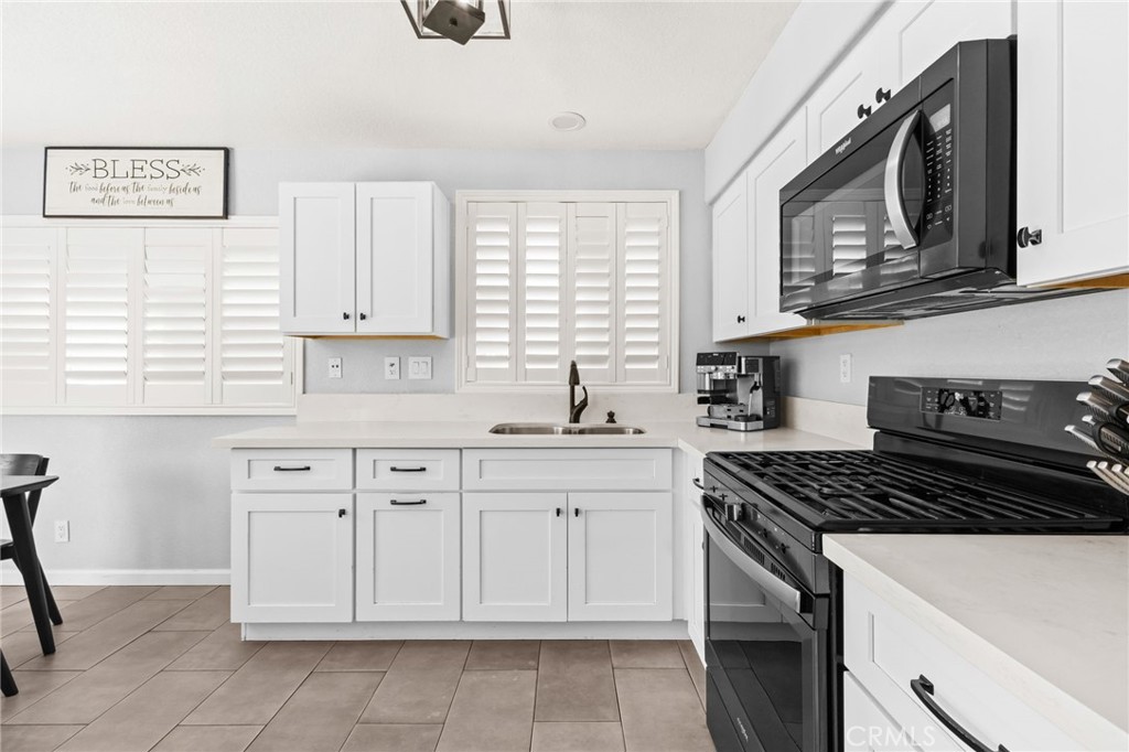 823 Pathfinder Way Corona, CA 92878 - Photo 23 of 59 a kitchen with cabinets appliances and a window