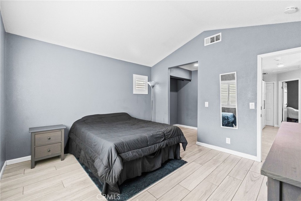 823 Pathfinder Way Corona, CA 92878 - Photo 28 of 59 a bedroom with a bed and wooden floor