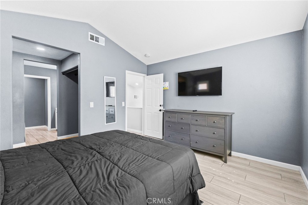 823 Pathfinder Way Corona, CA 92878 - Photo 29 of 59 a bedroom with a bed and a flat screen tv