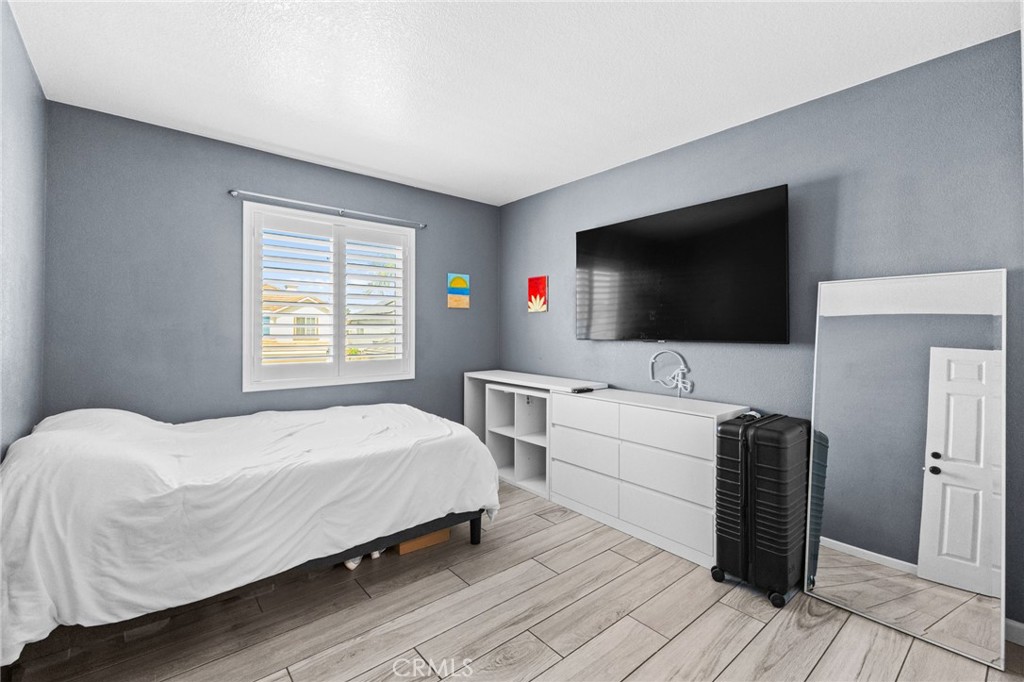 823 Pathfinder Way Corona, CA 92878 - Photo 34 of 59 a bedroom with a bed and a flat screen tv