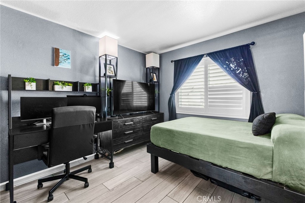 823 Pathfinder Way Corona, CA 92878 - Photo 37 of 59 a bedroom with a bed a desk and chair