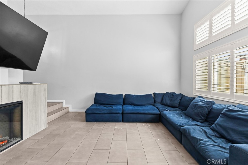 823 Pathfinder Way Corona, CA 92878 - Photo 10 of 59 a living room with a couch and a flat screen tv