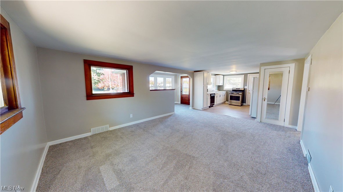 852 East Waterloo Road Akron, OH 44306 - Photo 13 of 24 Unfurnished living room featuring light carpet