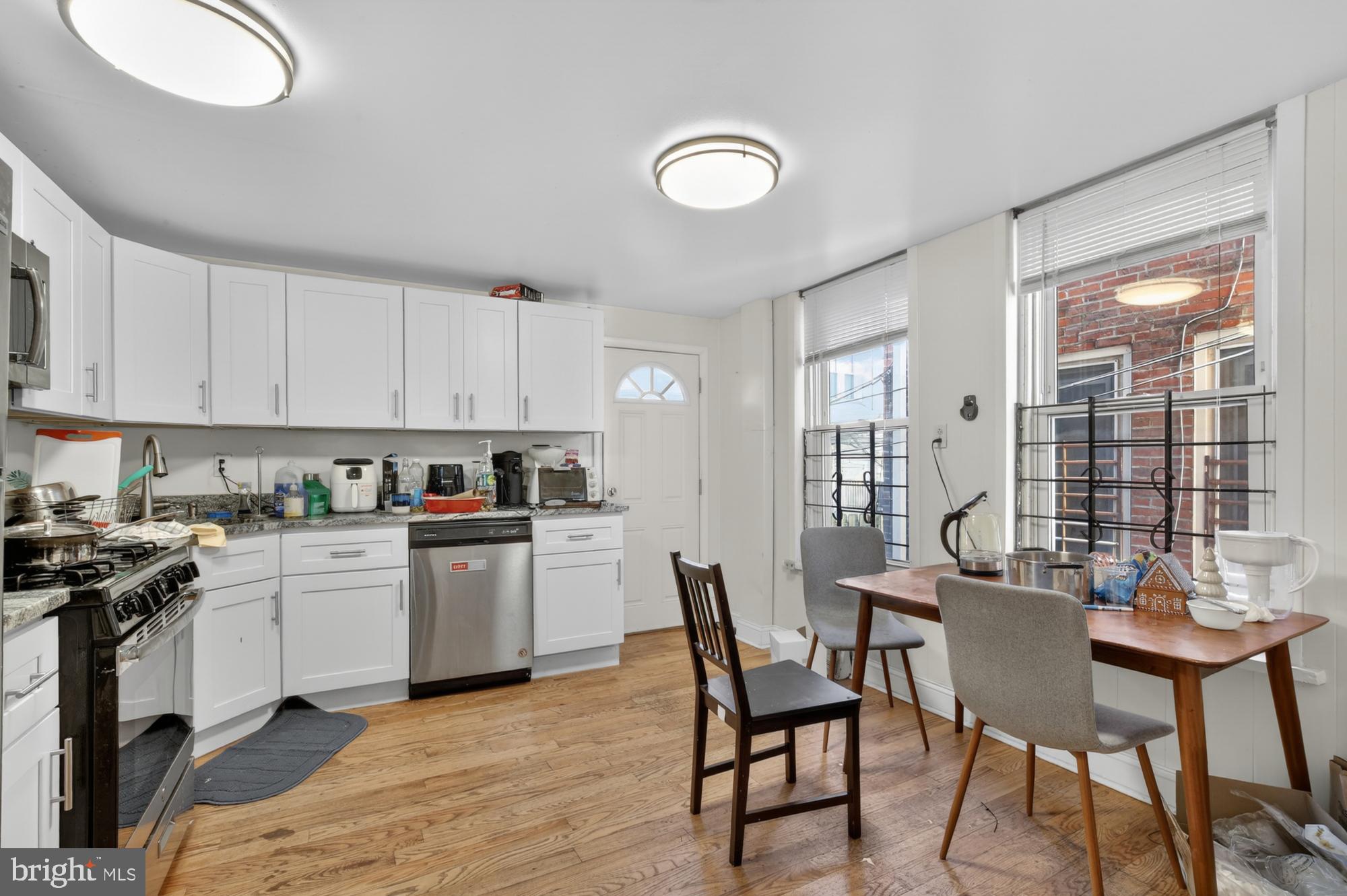 a kitchen with a table chairs sink and cabinets