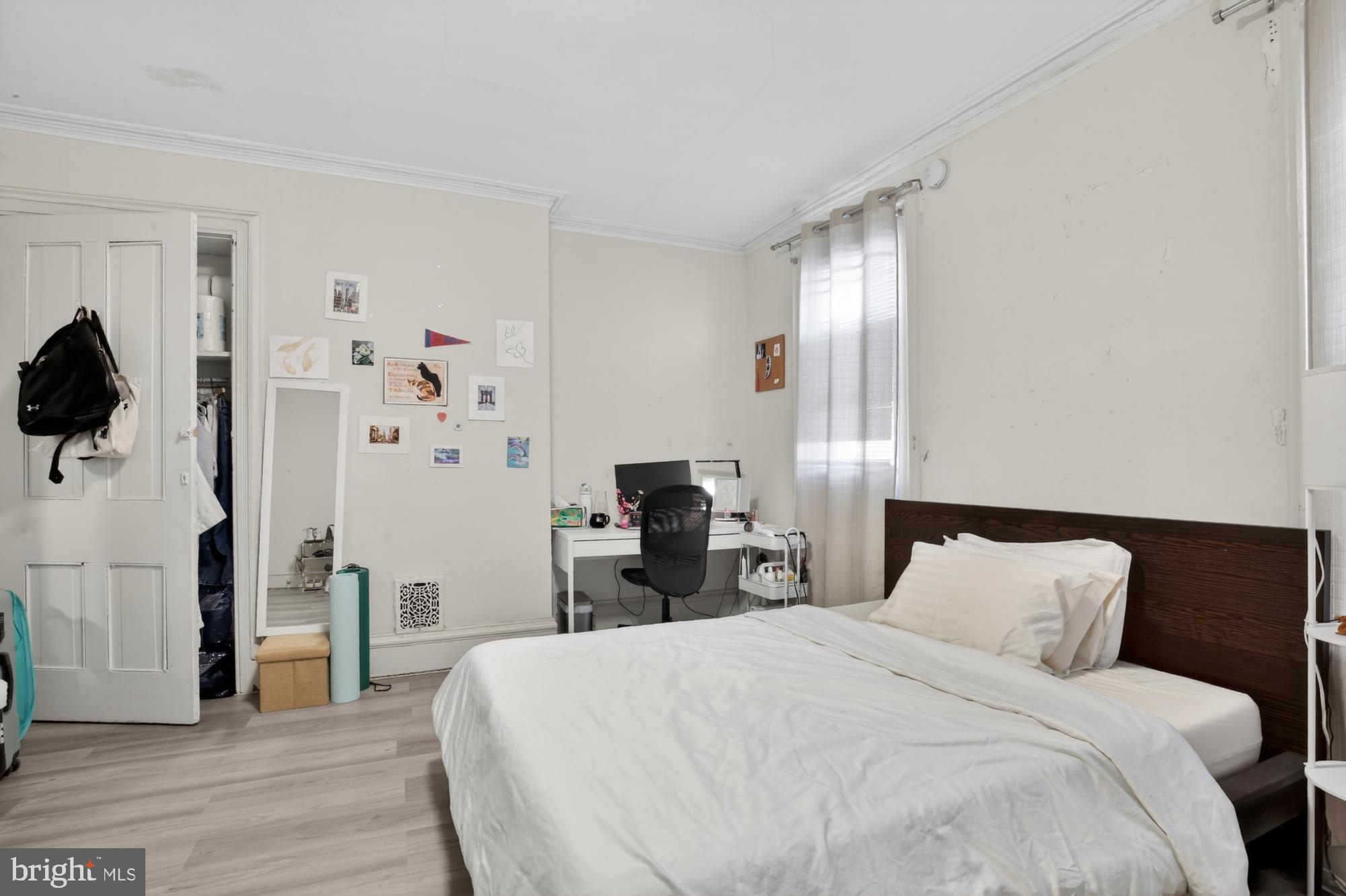 4058 Irving Street Philadelphia, PA 19104 - Photo 16 of 23 a bedroom with a bed and a large mirror