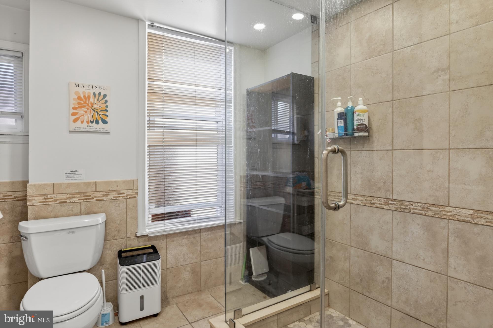 4058 Irving Street Philadelphia, PA 19104 - Photo 19 of 23 a bathroom with a toilet and a shower