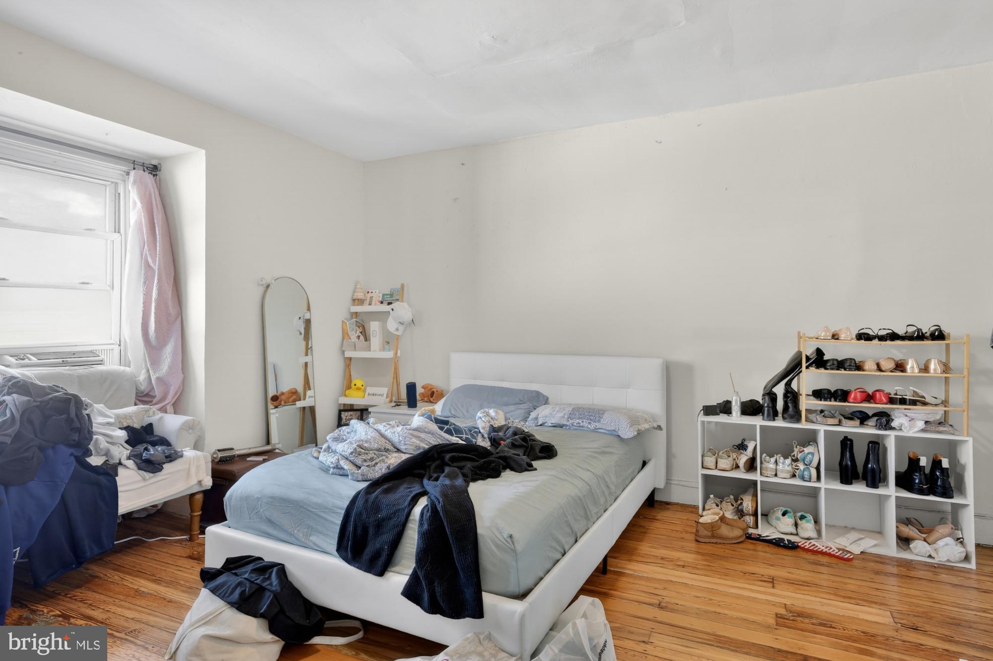 4058 Irving Street Philadelphia, PA 19104 - Photo 22 of 23 a bedroom with a bed and wooden floor