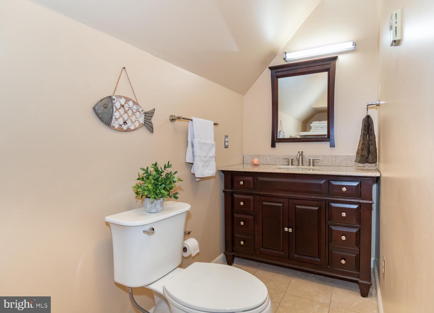 1015 Long Point Road Grasonville, MD 21638 - Photo 25 of 39 a bathroom with a toilet a sink and mirror
