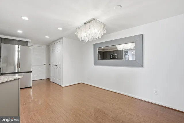 a view of an empty room with a kitchen