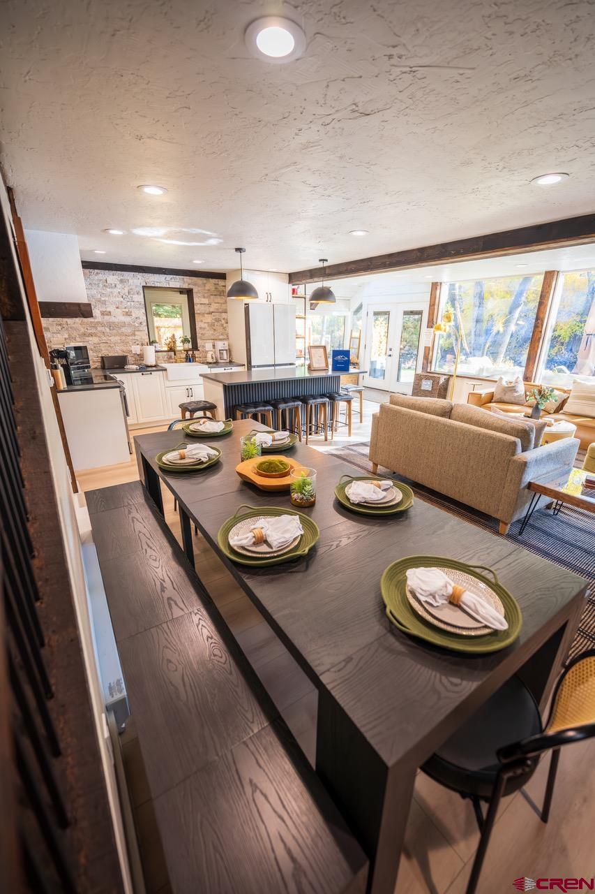 170 Lower Allen Road Crested Butte, CO 81224 - Photo 15 of 42 a dining room with furniture and a floor to ceiling window