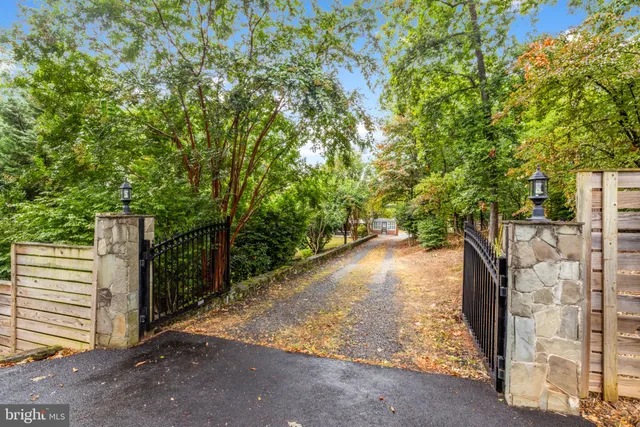 a view of a house with a yard and potted plants