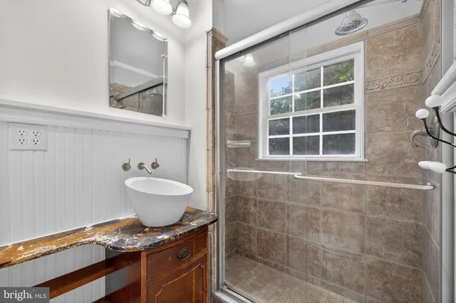 a view of a hallway with wooden floor and entryway