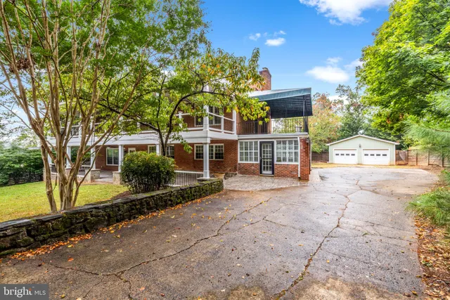a view of house with backyard space and balcony