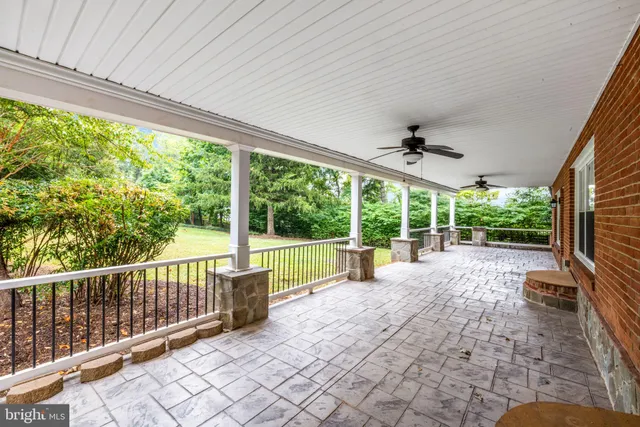 a kitchen with stainless steel appliances a refrigerator and wooden floor