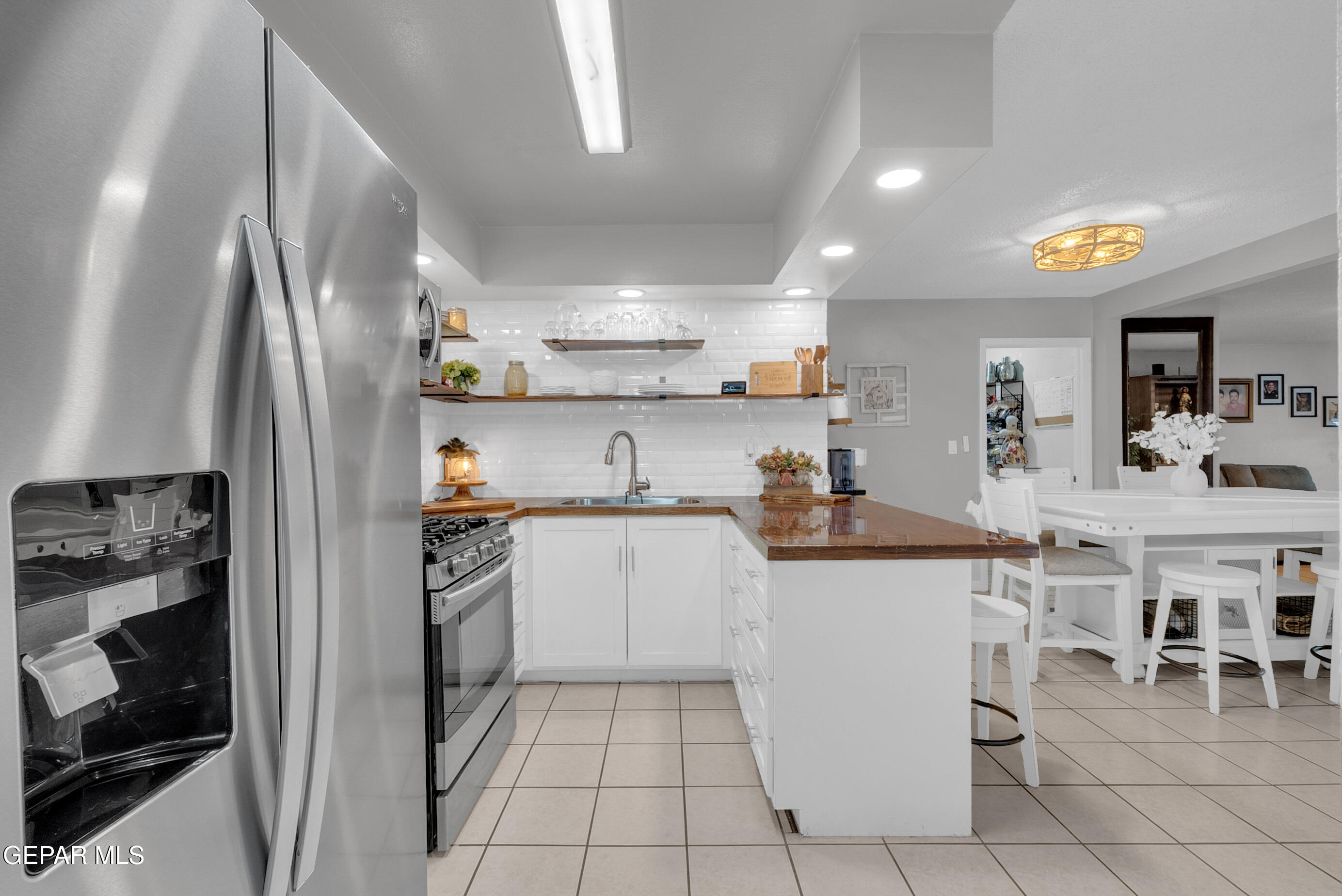 3444 Itasca Street El Paso, TX 79936 - Photo 12 of 88 a kitchen with cabinets and chairs