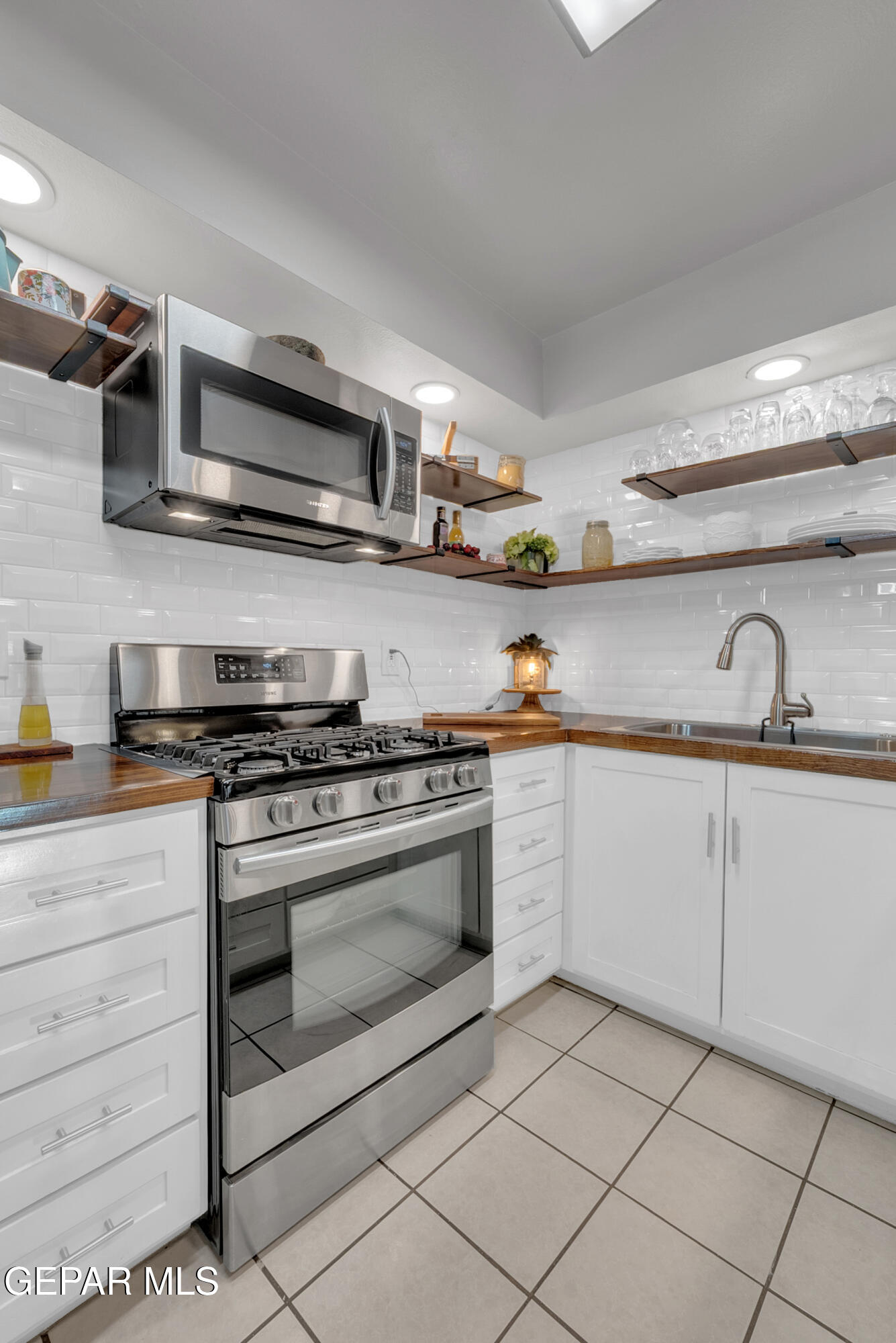 3444 Itasca Street El Paso, TX 79936 - Photo 15 of 88 a kitchen with stainless steel appliances granite countertop a sink and a stove