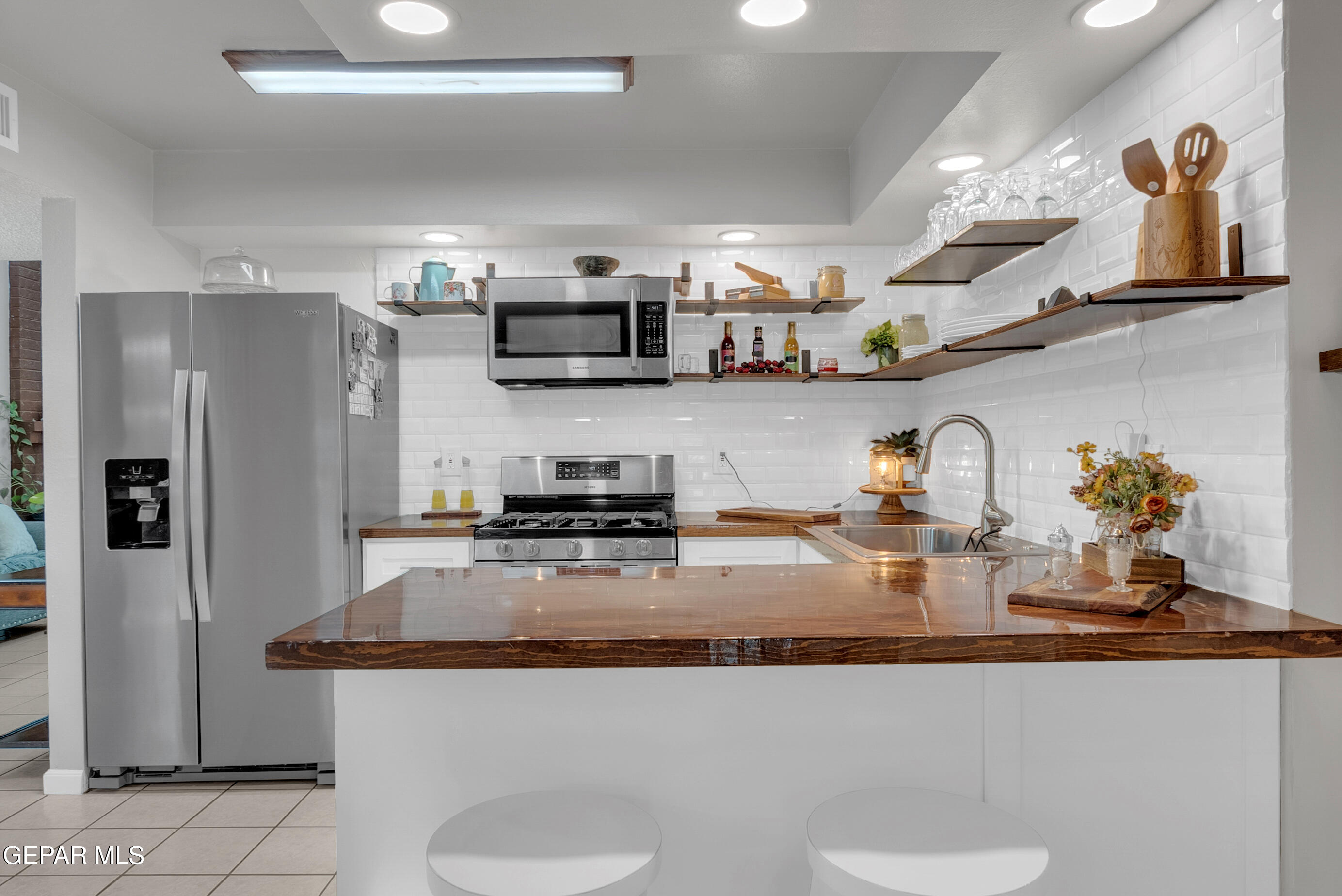 3444 Itasca Street El Paso, TX 79936 - Photo 19 of 88 a kitchen with stainless steel appliances granite countertop a sink a stove and a refrigerator