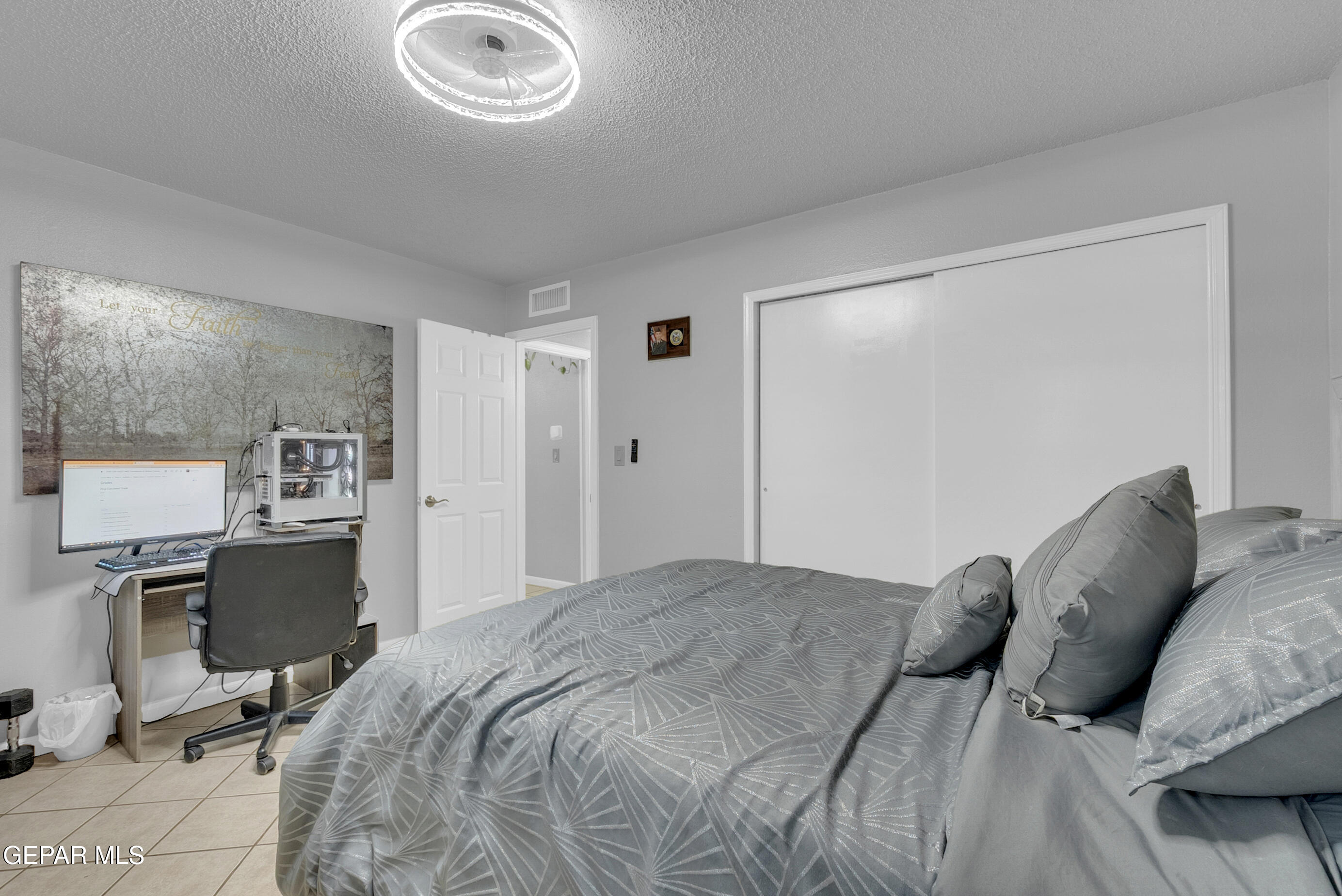 3444 Itasca Street El Paso, TX 79936 - Photo 38 of 88 a bedroom with a bed and a chandelier