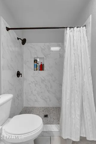 an aerial view of a house with a garden and lake view