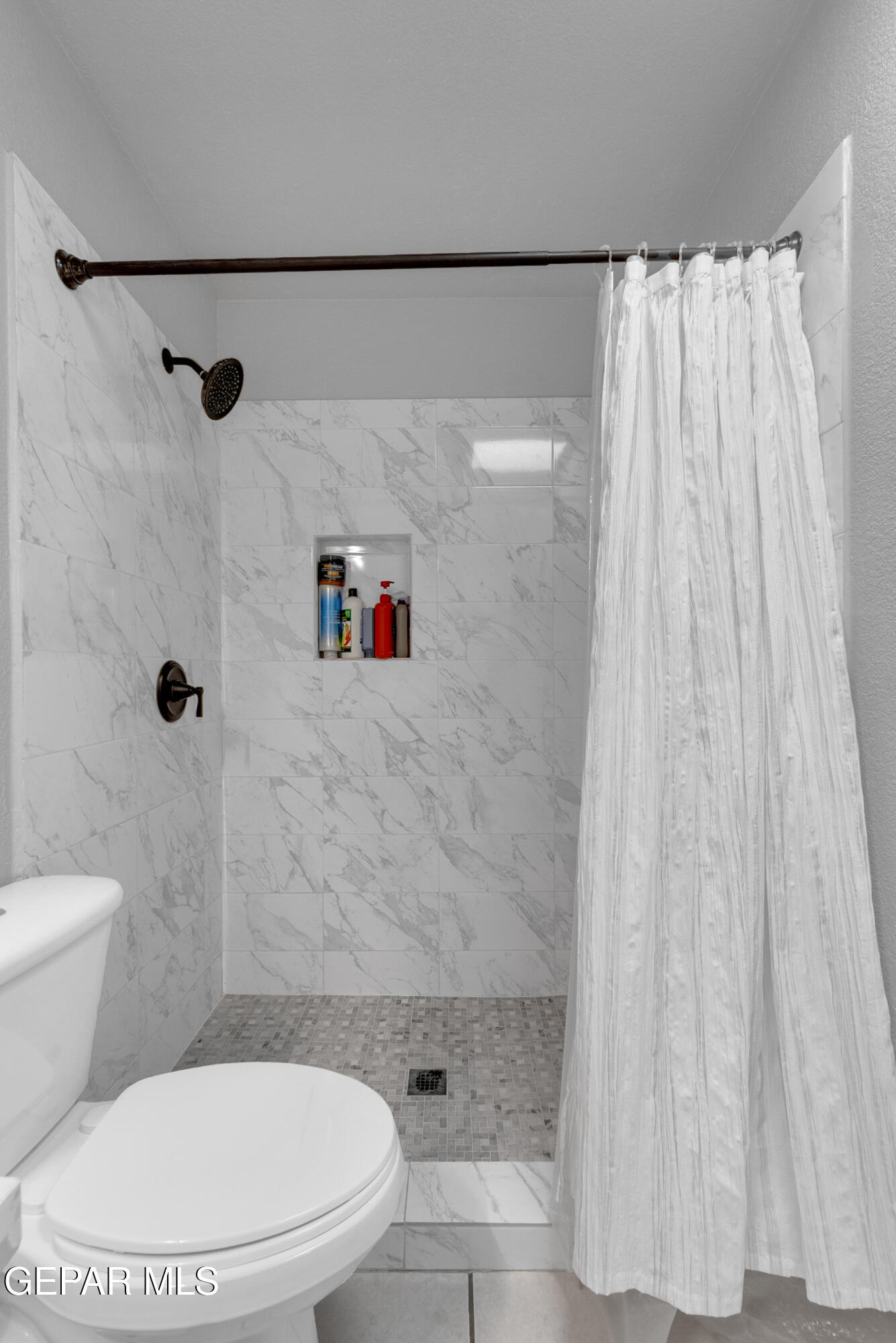 3444 Itasca Street El Paso, TX 79936 - Photo 42 of 88 a bathroom with a toilet and a shower curtain