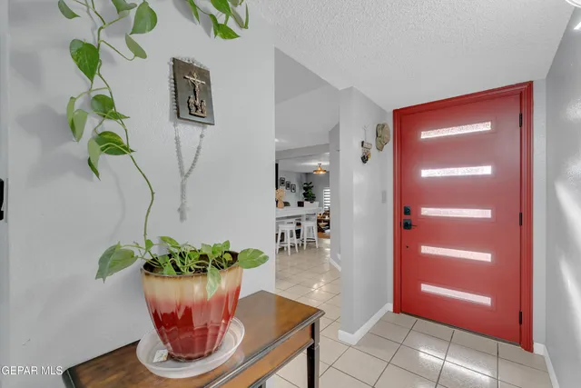 a kitchen with stainless steel appliances kitchen island granite countertop a refrigerator a stove and a dining table