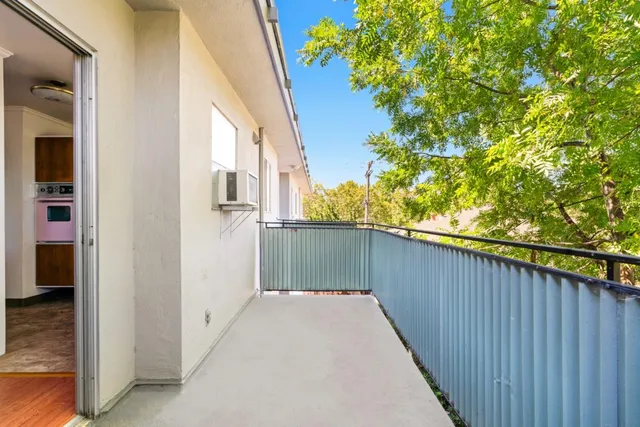 a balcony view with a backyard space