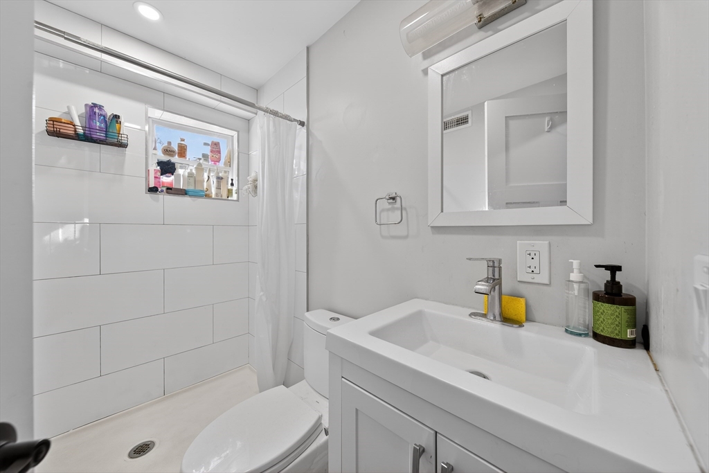 3 Walley Street Boston, MA 02128 - Photo 11 of 11 a bathroom with a sink a toilet and shower