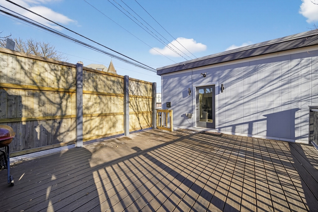 3 Walley Street Boston, MA 02128 - Photo 6 of 11 a view of a balcony with wooden floor and fence