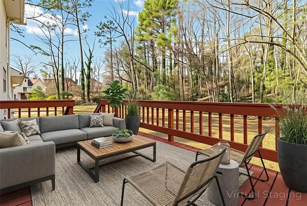 a roof deck with couches and wooden fence