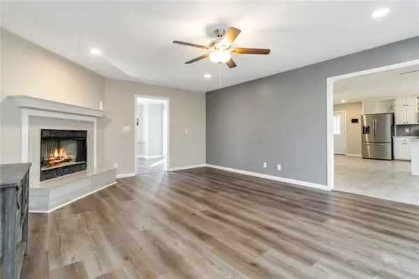 a view of an empty room with a fireplace and a window