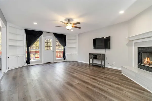 a large white kitchen with a stove a sink a window and a refrigerator